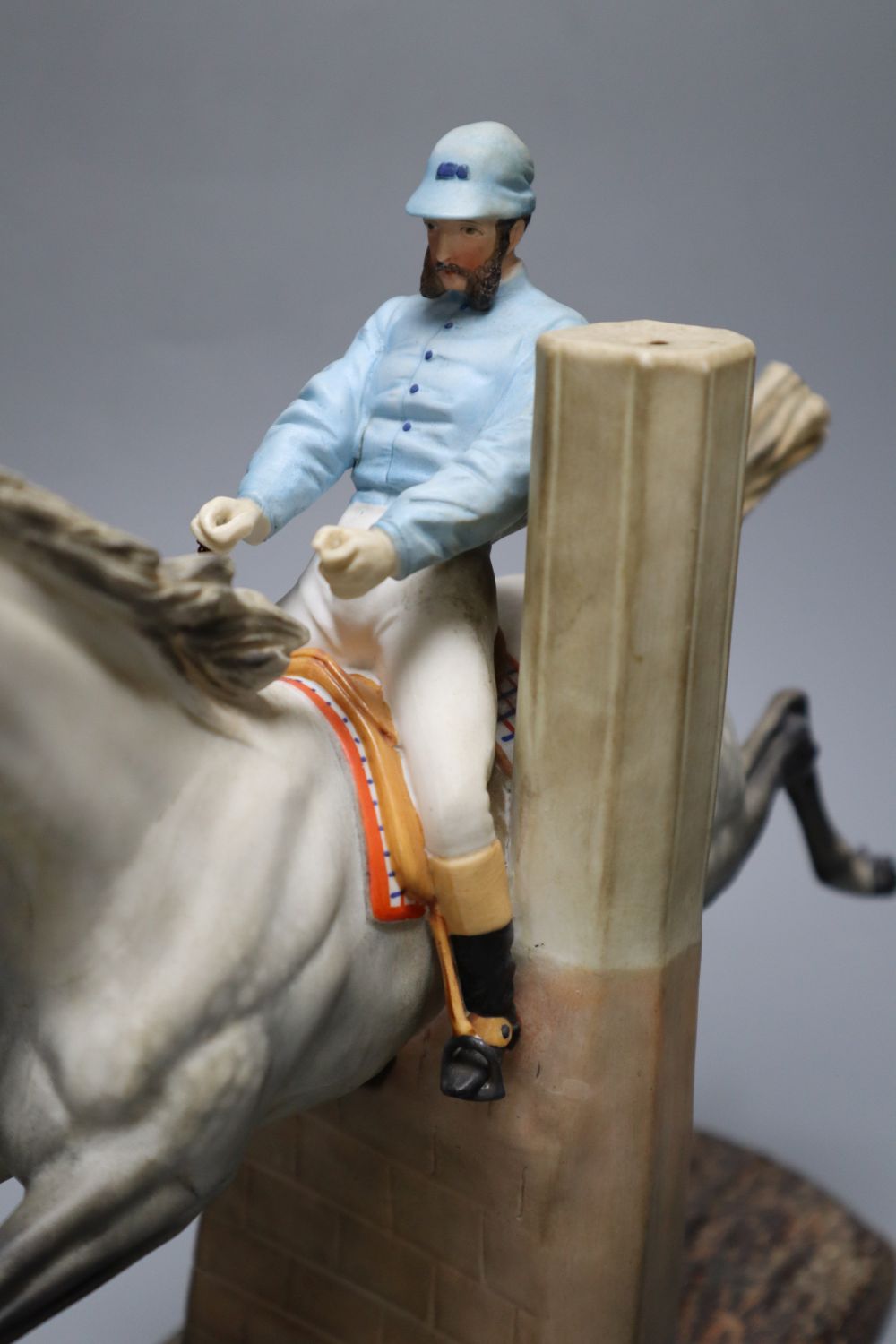 A cast coloured bisque porcelain horse and jockey group, height 26cm